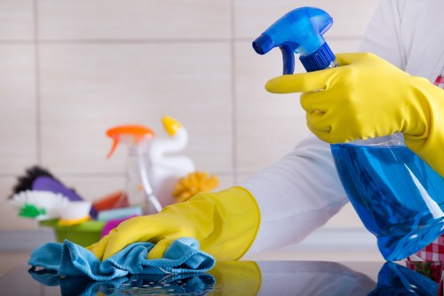 Cleaner vacuuming a shared hallway in an Ilford apartment block